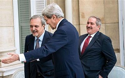 Jordanian Foreign Minister Nasser Judeh, right, US Secretary of State John Kerry, center, and Saudi Arabia's Foreign Minister Prince Saud al-Faisal walk to a meeting at the US Chief of Mission Residence in Paris, France, June 26, 2014 (photo credit: AP/Brendan Smialowski, pool)