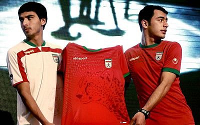Iranian soccer players Mohammad Reza Bazaj, right, and Meysam Joudaki present the Iranian national soccer team's newly designed t-shirt with an imprint of the endangered Asiatic Cheetah. (photo credit: AP Photo/Vahid Salemi/Ebrahim Noroozi)