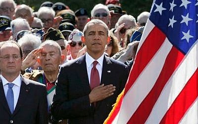 US President Barack Obama, center, and French President Francois Hollande, left, participate in the 70th French-American commemoration D-Day ceremony at the Normandy American Cemetery and Memorial in Colleville-sur-Mer, France on Friday, June 6, 2014 (photo credit: AP/Pascal Rossignol, Pool) 