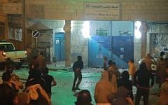 Palestinian youths attackinga PA polices station in Ramallah, early morning Sunday, June 22 2014. (photo credit: YouTube image capture)