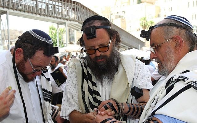 Rabbi Boaz Pash, center, at the bar mitzvah in Jerusalem of Mariusz Robert Aoflko, right, a 65-year old Jewish man from Krakow, in 2013. (Sasson Tiram/Shavei Israel/via JTA) Rabbi Boaz Pash, center, at the bar mitzvah in Jerusalem of Mariusz Robert Aoflko, right, a 65-year old Jewish man from Krakow, in 2013. (Sasson Tiram/Shavei Israel/via JTA)