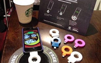 A cellphone recharging on a Powermat Spot at a California Starbucks (Photo credit: Courtesy)