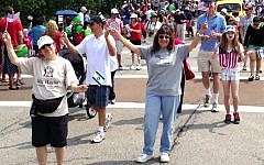 Members of the Aitz Hayim Center for Jewish Living in Glencoe, Ill., show U.S. and Israeli colors at the 2012 Fourth of July parade in nearby Highland Park. (Todd Jacobs/JTA)