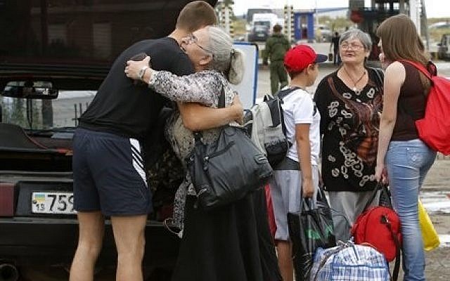 A man says goodbye to his relatives as they prepare to cross the border into Russia at the Ukrainian-Russian border checkpoint in Izvaryne, Luhansk region, eastern Ukraine Thursday, June 26, 2014. (photo credit: AP Photo/Dmitry Lovetsky) A man says goodbye to his relatives as they prepare to cross the border into Russia at the Ukrainian-Russian border checkpoint in Izvaryne, Luhansk region, eastern Ukraine Thursday, June 26, 2014. (photo credit: AP Photo/Dmitry Lovetsky)