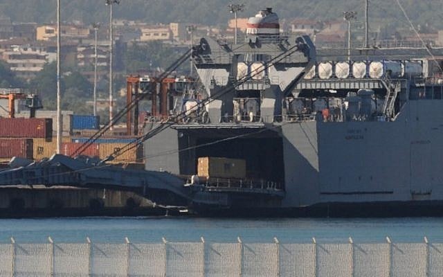 Containers of Syrian chemical weapons are transferred from a Danish freighter to a US military ship ahead of their destruction at sea on July 2, 2014 in the port of Gioia Tauro, southern Italy. (Photo credit: Mario Laporta/AFP)