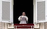 Pope Francis addresses faithful from the window of his study overlooking St. Peter's Square at the Vatican during his Sunday Angelus prayer on July 13, 2014. (photo credit: AFP/FILIPPO MONTEFORTE)