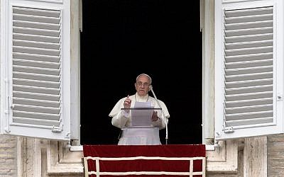 Pope Francis addresses faithful from the window of his study overlooking St. Peter's Square at the Vatican during his Sunday Angelus prayer on July 13, 2014. (photo credit: AFP/FILIPPO MONTEFORTE)