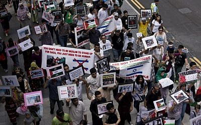 People march in Hong Kong to protest against Israel's military campaign in Gaza on July 13, 2014.  (photo credit: AFP/ALEX OGLE)