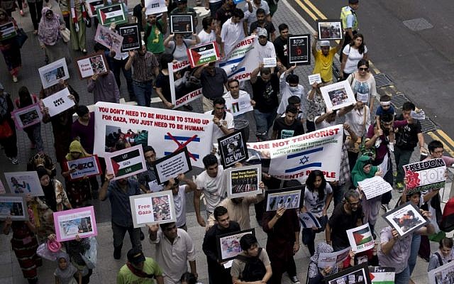 People march in Hong Kong to protest against Israel's military campaign in Gaza on July 13, 2014. (photo credit: AFP/ALEX OGLE) People march in Hong Kong to protest against Israel's military campaign in Gaza on July 13, 2014. (photo credit: AFP/ALEX OGLE)