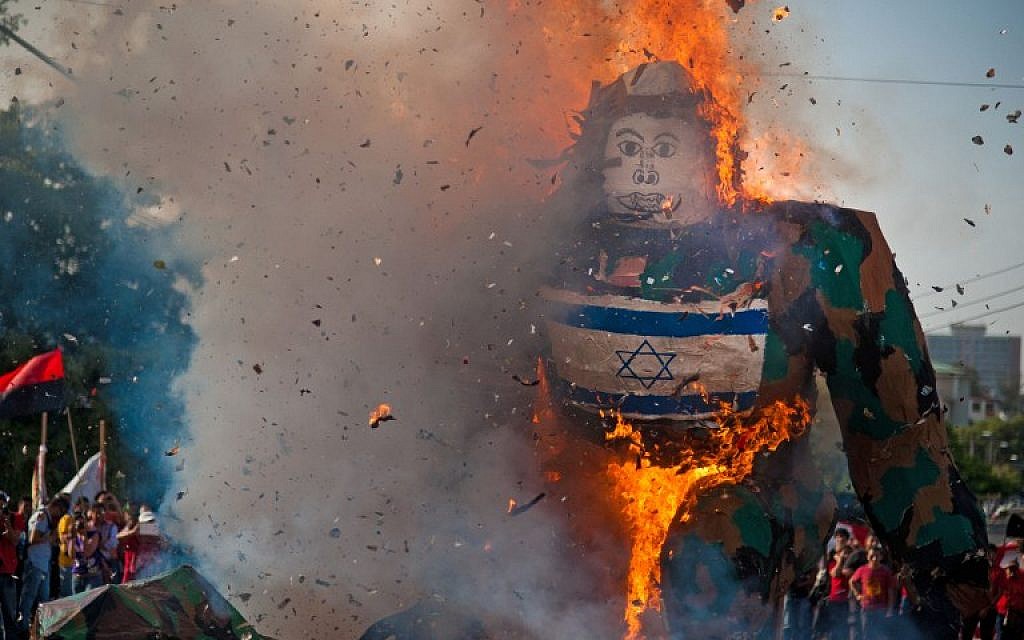 Salvadorean students burn a dummy with Israel's national flag as they protest against Israel's military action in the Gaza strip on July 30, 2014. (photo credit:AFP/ Jose Cabezas)