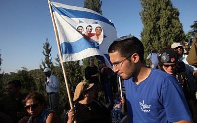 Tens of thousands Israelis attend the joint funeral of Gilad Shaar, 16, Naftali Fraenkel, 16, and Eyal Yifrach, 19, in the central Israeli town of Modiin on July 1, 2014. (photo credit: AFP/GIL COHEN MAGEN)