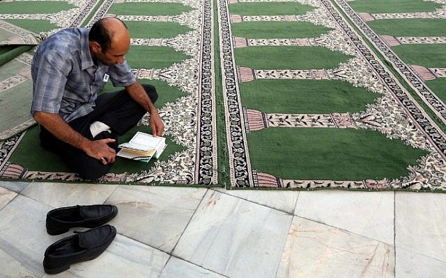 Illustrative photo of a Muslim man reading the Quran during the holy month of Ramadan (photo credit: Atta Kenare/AFP) Illustrative photo of a Muslim man reading the Quran during the holy month of Ramadan (photo credit: Atta Kenare/AFP)