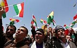 Iraqi Kurdish protesters wave flags of their autonomous Kurdistan region during a demonstration to claim for its independence on July 3, 2014, outside the Kurdistan parliament building in Arbil, in northern Iraq. (photo credit: AFP/Safin Hamed)