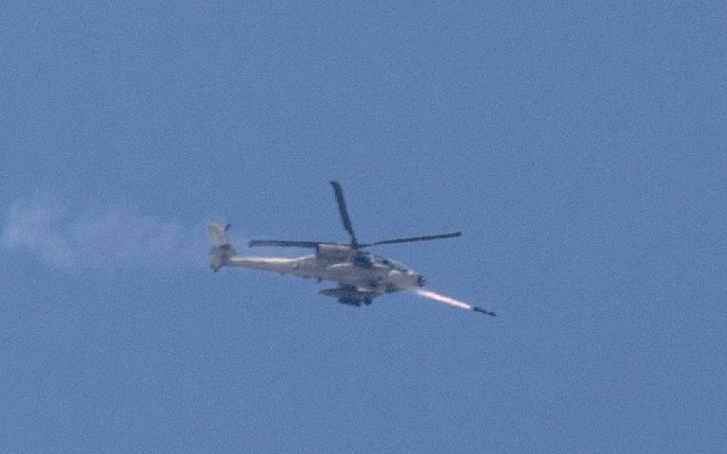 An Israeli Apache helicopter shoots a missile over the Gaza Strip as seen from Israel's border with Gaza on July 8, 2014 (photo credit: AFP/JACK GUEZ)