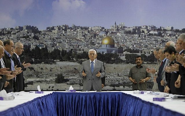 Palestinian Authority President Mahmoud Abbas (C) prays prior a meeting with his leadership in the West Bank city of Ramallah on July 9, 2014 (photo credit: AFP/ABBAS MOMANI) Palestinian Authority President Mahmoud Abbas (C) prays prior a meeting with his leadership in the West Bank city of Ramallah on July 9, 2014 (photo credit: AFP/ABBAS MOMANI)
