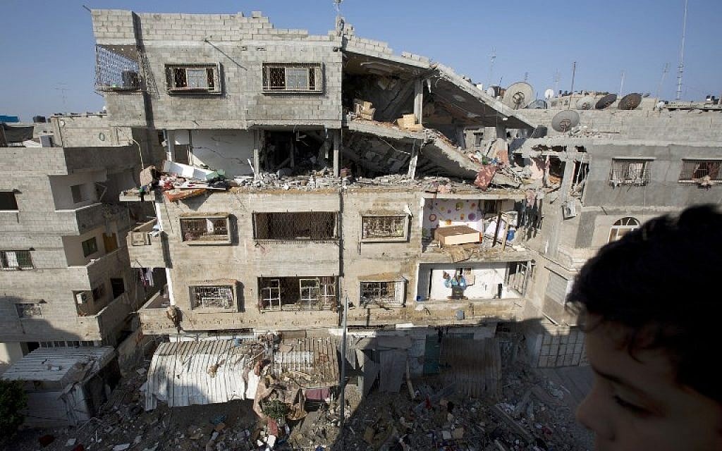A picture taken in Gaza City on July 10, 2014 shows a damaged building after it was hit by an Israeli air strike. (photo credit: AFP / MOHAMMED ABED)