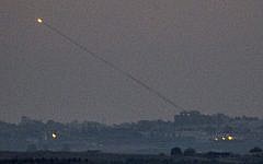 A picture taken from the southern Israeli Gaza border shows a rocket being launched from the Gaza strip into Israel on Thursday, July 10, 2014. (photo credit: Jack Guez/AFP)