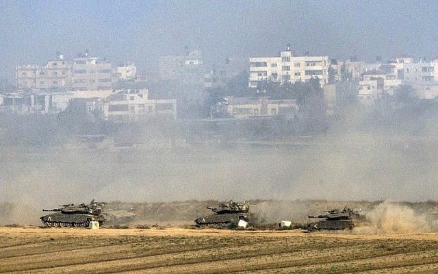 Illustrative. Israeli Merkava tanks fire at the Gaza Strip from inside Israel on July 20, 2014. (AFP/JACK GUEZ) Illustrative. Israeli Merkava tanks fire at the Gaza Strip from inside Israel on July 20, 2014. (AFP/JACK GUEZ)