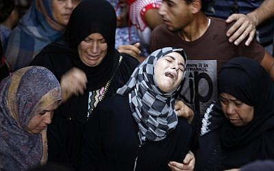 Palestinian relatives of Hasan Baker, 60, grieve during his funeral in Gaza City, July 22, 2014. (photo credit: AFP PHOTO / MOHAMMED ABED)