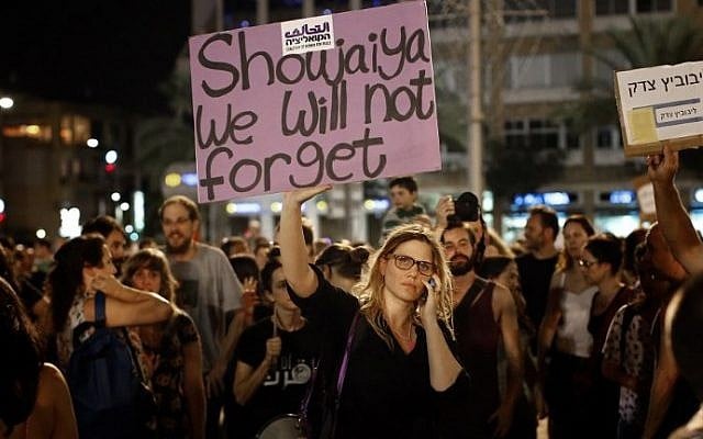 Am activist raises up a placard as thousands of gather at the Rabin Square in Tel Aviv on July 26, 2014, to call for the end of hostilities in the Gaza Strip (Photo credit Thomas Coex/AFP) Am activist raises up a placard as thousands of gather at the Rabin Square in Tel Aviv on July 26, 2014, to call for the end of hostilities in the Gaza Strip (Photo credit Thomas Coex/AFP)