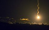 A picture taken from the southern Israeli border with the Gaza Strip shows Israeli flares illuminating the Palestinian coastal enclave, on July 7, 2014. (photo credit: AFP/JACK GUEZ)