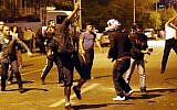 Demonstrators throw stones at the Israeli Embassy in Ankara, as they protest against Israel's military action in Gaza, on July 18, 2014. (photo credit: AFP/Adem Altan)