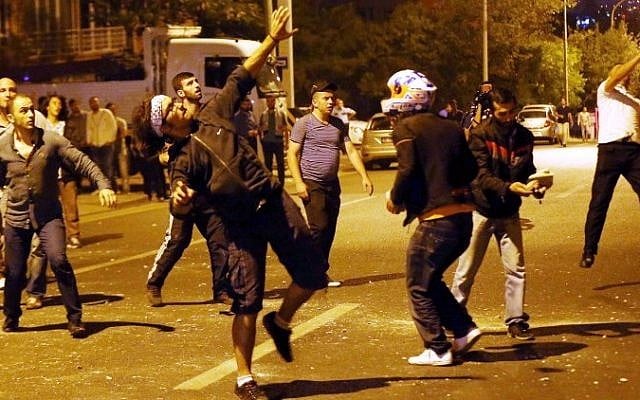 Demonstrators throw stones at the Israeli Embassy in Ankara, as they protest against Israel's military action in Gaza, on July 18, 2014. (photo credit: AFP/Adem Altan) Demonstrators throw stones at the Israeli Embassy in Ankara, as they protest against Israel's military action in Gaza, on July 18, 2014. (photo credit: AFP/Adem Altan)
