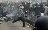 FILE: Rioters throw projectiles at French riot police officers in Sarcelles, a suburb north of Paris, on July 20, 2014, after clashes following a demonstration denouncing Israel's military campaign in Gaza. (Photo credit: AFP/ PIERRE ANDRIEU