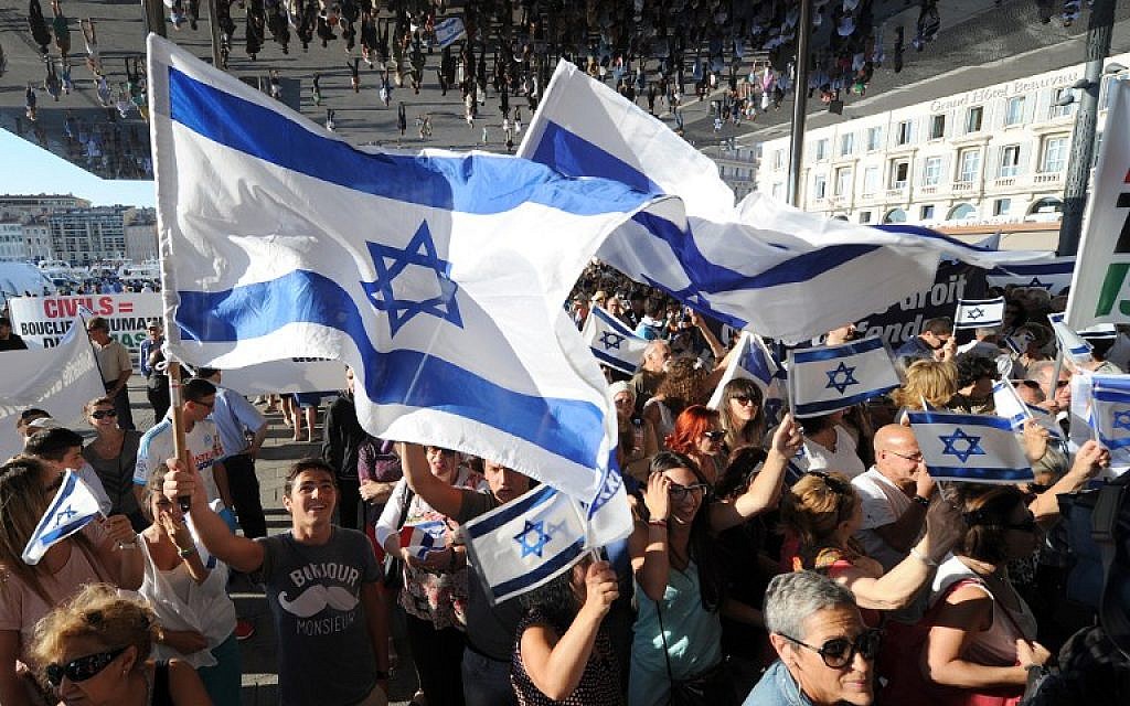Illustrative: People wave Israeli flags as they take part in a demonstration supporting Israel in Marseille, southeastern France, on July 27, 2014. (AFP/Boris Horvat) Illustrative: People wave Israeli flags as they take part in a demonstration supporting Israel in Marseille, southeastern France, on July 27, 2014. (AFP/Boris Horvat)