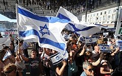 Illustrative: People wave Israeli flags as they take part in a demonstration supporting Israel in Marseille, southeastern France, on July 27, 2014. (AFP/Boris Horvat)