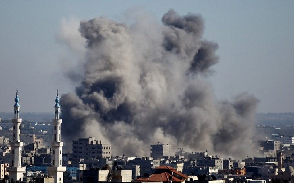 Smoke billows from buildings following an Israeli air strike on Gaza City on July 11, 2014. (photo credit: Mohammed Othman/AFP)