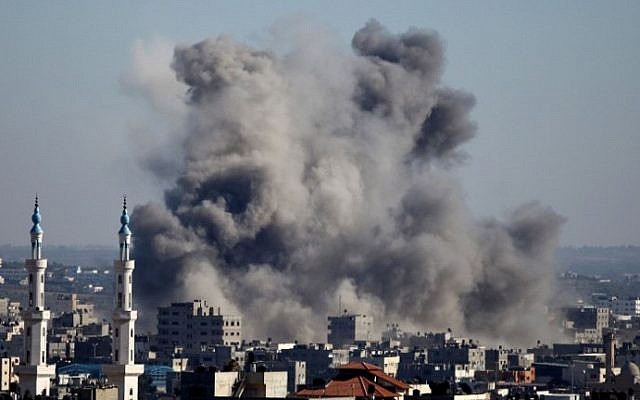Smoke billows from buildings following an Israeli air strike on Gaza City on July 11, 2014. (photo credit: Mohammed Othman/AFP) Smoke billows from buildings following an Israeli air strike on Gaza City on July 11, 2014. (photo credit: Mohammed Othman/AFP)