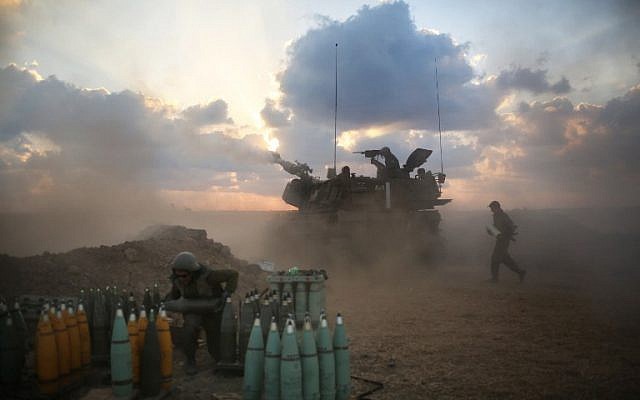 Israeli soldiers fire towards the Gaza Strip from their position near Israel's border with the coastal Palestinian enclave on July 19, 2014. (photo credit: AFP/MENAHEM KAHANA) Israeli soldiers fire towards the Gaza Strip from their position near Israel's border with the coastal Palestinian enclave on July 19, 2014. (photo credit: AFP/MENAHEM KAHANA)