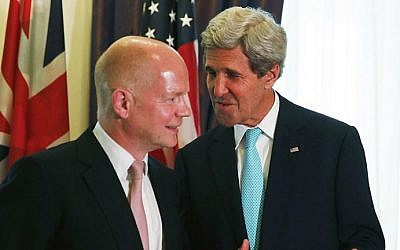 British Foreign Secretary William Hague (L) talks with US Secretary of State John Kerry (R) during a bilateral meeting during talks between the foreign ministers of the six powers negotiating with Tehran on its nuclear program, in Vienna, on July 13, 2014. (photo credit: JIM BOURG/POOL/AFP)
