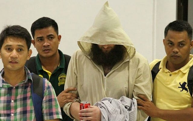 Philippine Immigration officers escort Robert Edward Cerantonio (C), an Australian convert to Islam who used the internet to urge people to join "jihad" in Iraq and Syria, seen here in in Cebu City July 11, 2014. (photo credit: AFP) Philippine Immigration officers escort Robert Edward Cerantonio (C), an Australian convert to Islam who used the internet to urge people to join "jihad" in Iraq and Syria, seen here in in Cebu City July 11, 2014. (photo credit: AFP)