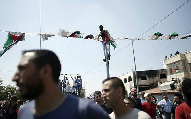 Mourners protest as they gather for the funeral of Palestinian youth Mohammed Abu Khdeir, 16, in Shuafat, in Israeli annexed East Jerusalem, on July 4, 2014 (photo credit: AFP/ Thomas Coex)