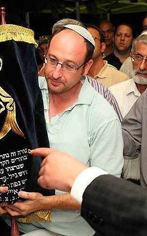 Ophir Shaar with the Torah scroll dedicated to the memory of his late son, Gil-ad, as well as Eyal Yifrach and Naftali Fraenkel (photo credit: Michal Aviad/Courtesy)