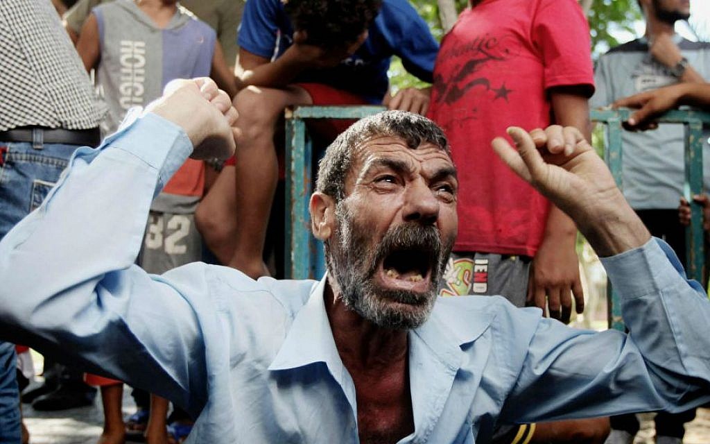 Palestinian relatives of four boys from the same extended Bakr family grieve during their funeral in Gaza City, Wednesday, July 16, 2014 (photo credit: Emad Nassar/Flash90)