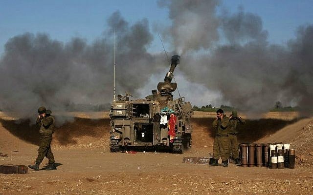A 155mm artillery tank, positioned near the Israeli border with the Gaza Strip, fires a projectile towards targets in the Palestinian enclave, on July 17, 2014 (photo credit: AFP/Menahem Kahana) A 155mm artillery tank, positioned near the Israeli border with the Gaza Strip, fires a projectile towards targets in the Palestinian enclave, on July 17, 2014 (photo credit: AFP/Menahem Kahana)