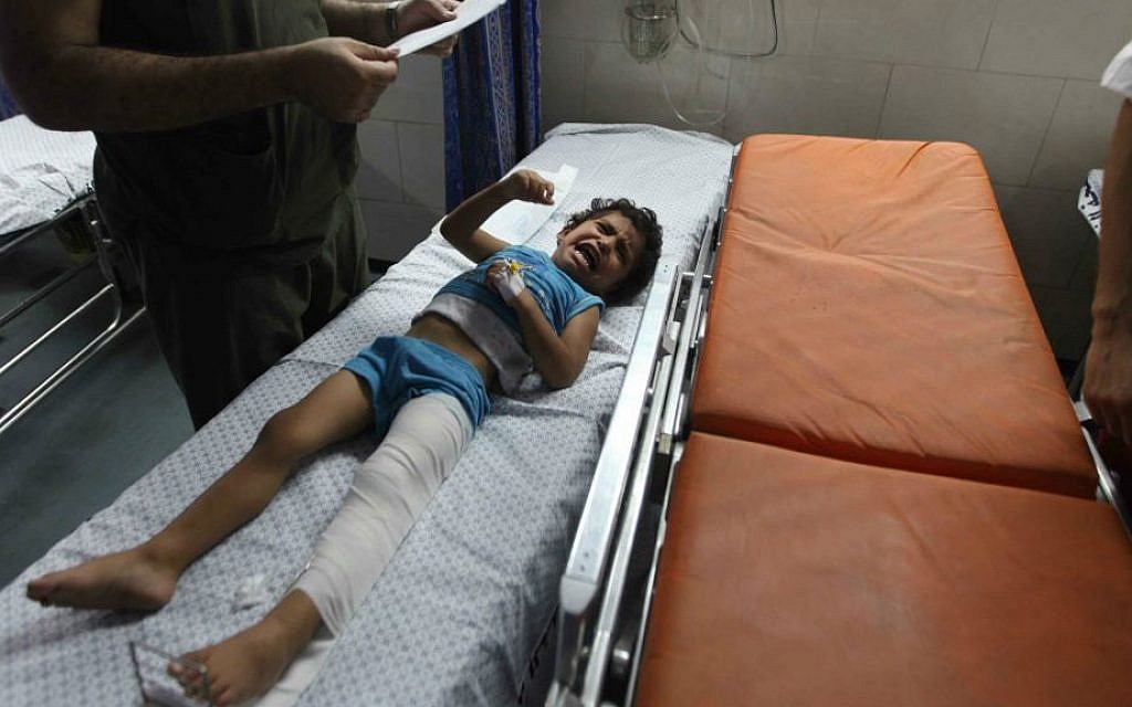 A wounded girl is treated at the emergency room of the Shifa hospital in Gaza, Friday, July 18, 2014 (photo credit: Emad Nassar/Flash90)