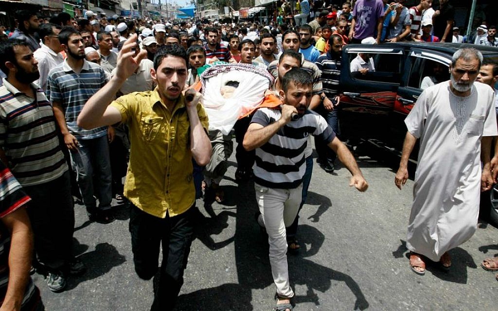 Palestinians carry the body of a Hamas operative, who medics said was killed by an Israeli air strike which took place before a five-hour humanitarian truce, during his funeral in Rafah in the southern Gaza Strip on July 17, 2014 (photo credit: Abed Rahim Khatib/Flash90)