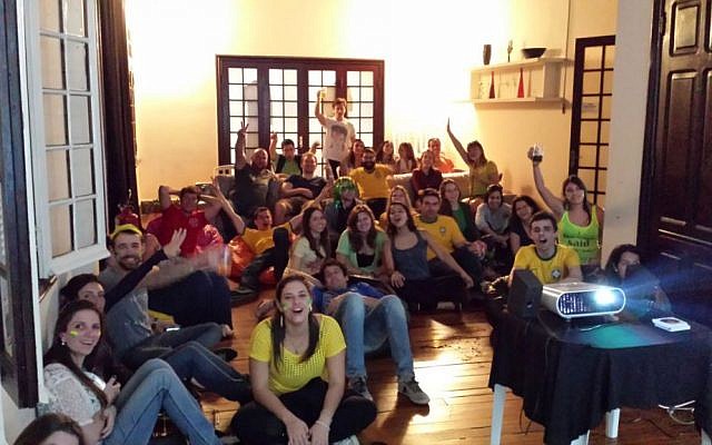 Group of people: Espaço K, a Jewish youth center in São Paulo, hosted a viewing party for Brazil's opening game against Croatia on June 12. Since having qualified for the knockout round, however, the Jewish community has had to endure game times in the middle of Shabbat. (courtesy: Pessach Kauffman) Group of people: Espaço K, a Jewish youth center in São Paulo, hosted a viewing party for Brazil's opening game against Croatia on June 12. Since having qualified for the knockout round, however, the Jewish community has had to endure game times in the middle of Shabbat. (courtesy: Pessach Kauffman)