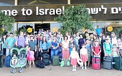 A group of 64 immigrants who arrived in Israel on Tuesday, July 8, 2014, after the commencement of Operation Protective Edge in the Gaza Strip. (photo credit: Sasson Tiram/Nefesh B'Nefesh)