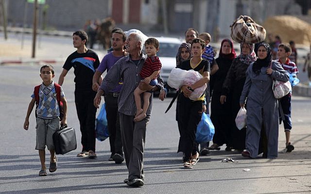 Palestinians flee their homes to take shelter at the United Nations school in Gaza City, Sunday, July 13, 2014.  (photo credit: AP/Hatem Moussa)