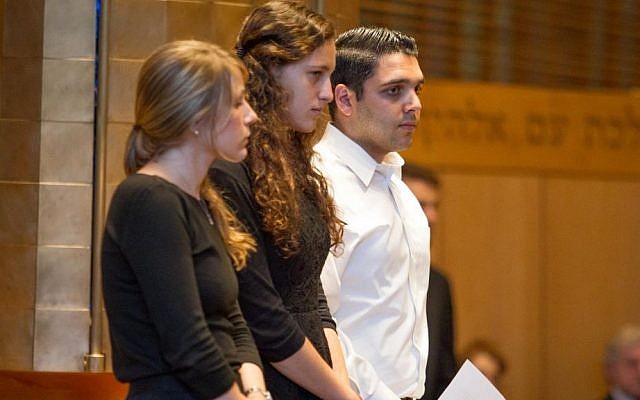 Boston-area students (from left) Aviva Malveira, Amanda Jowell and Arthur Maserjian read biographies of the three murdered teenagers (photo credit: Elan Kawesch/Times of Israel) Boston-area students (from left) Aviva Malveira, Amanda Jowell and Arthur Maserjian read biographies of the three murdered teenagers (photo credit: Elan Kawesch/Times of Israel)