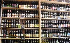 The Tel Aviv Carmel Market's Beer Bazaar, tucked amongst the crowded and colorful stalls, has 92 different varieties of Israeli beer, including its own brew (photo credit: Melanie Lidman/Times of Israel)