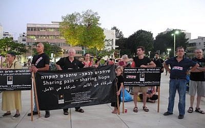 Members of the Parents Circle, who have lost a loved one in the Israeli-Palestinian conflict, demonstrating in Tel Aviv, July 3, 2013. (photo credit: Melanie Lidman)