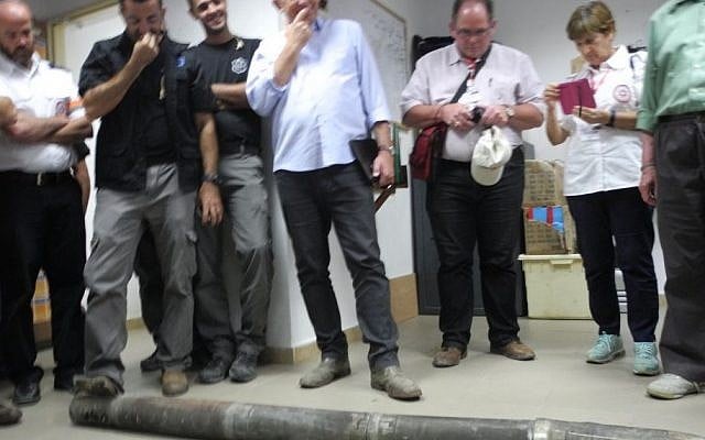 International supporters of Magen David Adom on Wednesday, July 30, 2014, stand alongside a two-meter-long Grad rocket that landed outside of Netivot (photo credit: Melanie Lidman/Times of Israel) International supporters of Magen David Adom on Wednesday, July 30, 2014, stand alongside a two-meter-long Grad rocket that landed outside of Netivot (photo credit: Melanie Lidman/Times of Israel)