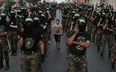 Members of the Izz ad-Din al-Qassam Brigades, Hamas's armed wing, stage an anti-Israel parade as part of the celebrations marking the first anniversary of an Israeli army operation in Gaza, November 14, 2013 (photo credit: Wissam Nassar/Flash90)