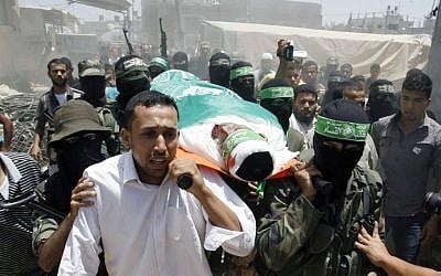 Palestinian militants of the Izz ad-Din al-Qassam Brigades, Hamas's armed wing, carry the body of militant Mohammed Obied during his funeral in the town of Deir al-Balah, in the central Gaza Strip on June 30, 2014 (photo credit: Abed Rahim Khatib/Flash90)